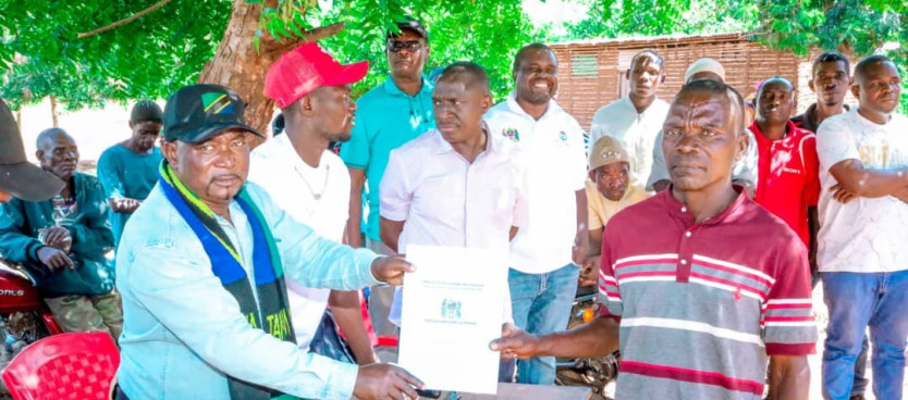 Mkurugenzi Mtendaji wa Halmashauri ya Wilaya ya Ruangwa Bw. Frank Chonya akikabidhi Hati ya Hakimiliki ya Kimila kwa Mwananchi wa Kijiji cha Nambilanje wakati wa Hafla ya kukabidhi Hatimiliki hizo iliyofanyika Kijijini hapo tarehe 23/07/2025